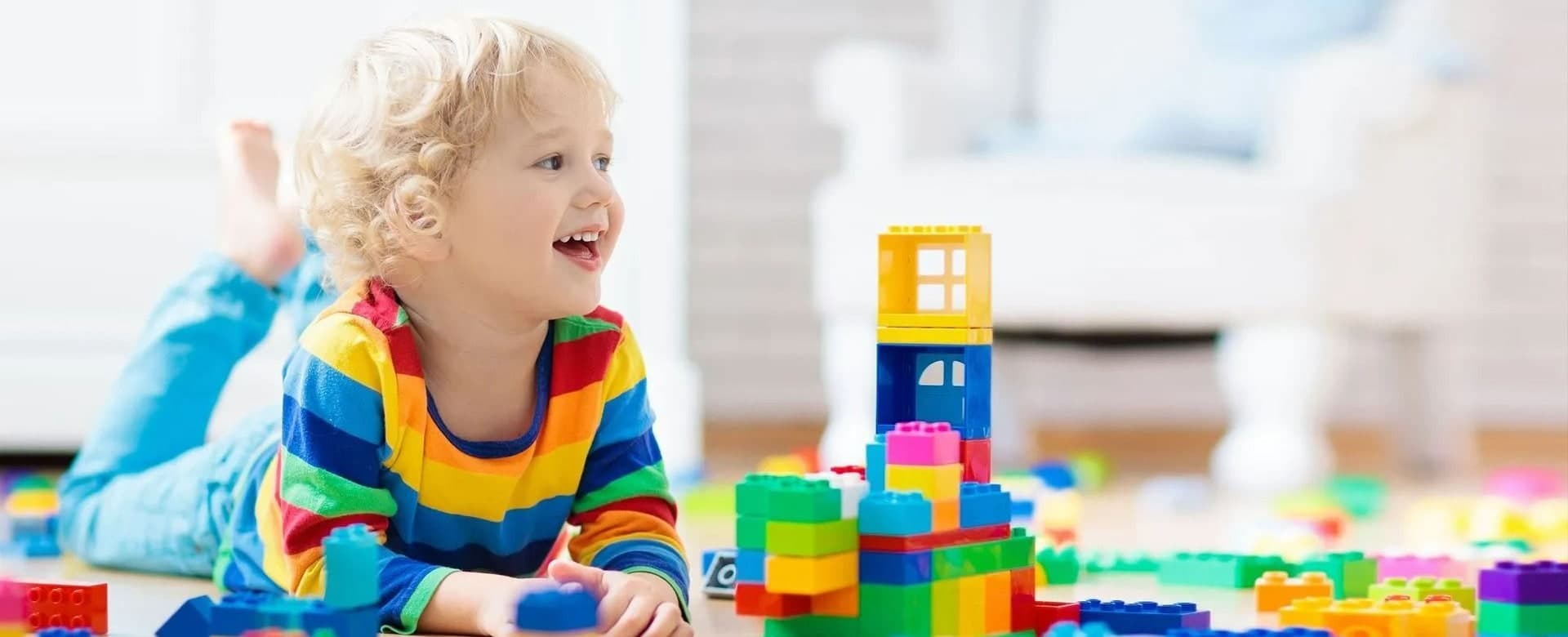 A young child enjoying colorful building blocks, from Vinings Academy’s website
